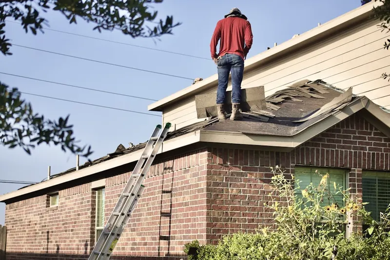 Professional roofer working on a residential roof in Lido Beach